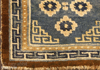 Antique Tibetan Mat 59 × 55 cm (1' 11" × 1' 9") | Contact: info@mollaianrugs.com |


A fine Tibetan mat
The medium-blue field with four rosettes and key-pattern spandrels. In key-pattern border between pearl-seed  ...