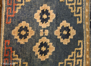 Antique Tibetan Mat 59 × 55 cm (1' 11" × 1' 9") | Contact: info@mollaianrugs.com |


A fine Tibetan mat
The medium-blue field with four rosettes and key-pattern spandrels. In key-pattern border between pearl-seed  ...
