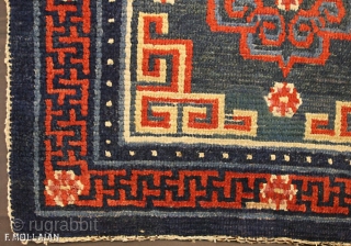 An antique Tibetan mat, 1880-1900

Classic for this type with central floral roundel flamed by key-pattern spandrel. In Buddhist motif and lotus flowerhead border between pearl-seed and plain stripes. This mat has slight  ...