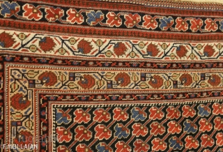 This is a Khamseh rug from southwest Persia and it was woven circa 1880. The field has been designed using an allover repeating flower design. The three borders are constructed using floral  ...