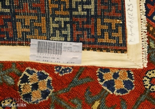 Antique Khotan Rug, 19th Century,

The abrashed rust field with overall design of angular polychrome rosette and leafy vine. In   multicoloured open and linked squares containing Buddhist motifs between barber-pole and  ...