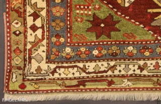 A fine Kazak rug, South Caucasus.

The abrashed deep rust field with various angular floral motifs and hooked panels around double hooked octagon medallions containing hooked bars, Green stellar flower head and animal  ...