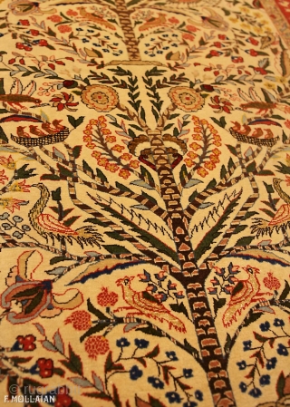 This is an antique Qum rug from central Persia woven between the 1920-1950s. The rug has a tree of life design with many different flower and bird motifs. The rug has been  ...
