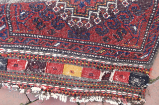 Antique Baluchi Bag c. 19th cent-- approx 18 x 20”

Red field with single medallion and animal figures in corners. Gray striped back. Rare “left hand knotting—(in which the open side is right).  ...