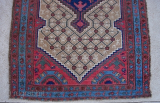 Camel Hamadan -- 4 ft 2 by 6 ft 6 inches. Decorative. Some pile wear but little exposed foundation. Original side overcast is worn. Frayed edge on the lower right hand corner.
 