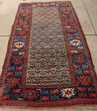 Sauj Bulaq Kurd 4 x 8.4 ft., circa 1890.  Great fat Genge border with wonderful clear natural reds, green, some aubergine; the field design is what Stone 2004:216 identified as "Sauj  ...