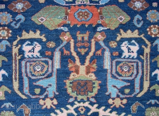 West Persian Tribal rug 4 ft 2 inches x 6 ft 0 inches. Can anyone identify this strange smiling animal? Looks like maybe a cat with a bird sitting on his shoulder??  ...
