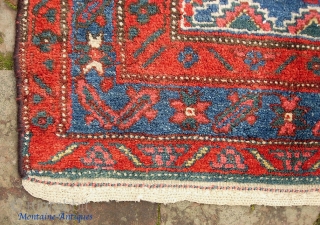 Kurdish-- 4 ft 10 inches x 7 ft 6 inches. Light tan wool foundation. Original braided end. Some pile wear and a bit of exposed foundation in the blue on one side  ...