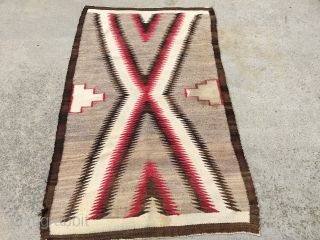 As found: Vintage Navajo rug measuring 3'5"x 5'8" with a stain of unknown substance in one of the ivory blocks in the middle of the rug.  Also a faint discoloration at  ...