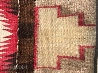 As found: Vintage Navajo rug measuring 3'5"x 5'8" with a stain of unknown substance in one of the ivory blocks in the middle of the rug.  Also a faint discoloration at  ...