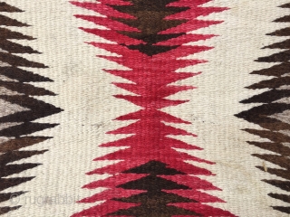 As found: Vintage Navajo rug measuring 3'5"x 5'8" with a stain of unknown substance in one of the ivory blocks in the middle of the rug.  Also a faint discoloration at  ...