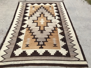 Very early 20th century large Navajo measuring 5’10”x8’6”, has a few holes and needs some other touch ups.               