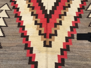 Nice old Navajo measuring 5'x 9'5" with 6 warps and 12 wefts per square inch with slight yellow stains in the ivory part of the medallion, lower half, with one side being  ...