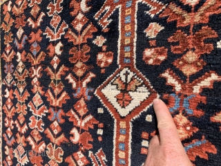 1920’s-30’s southern Iranian tribal rug (Bavanat) that’s been cut and shut at the two small white pendants flanking the medallion. Rug measures 5’x 7’10”.         