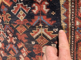 1920’s-30’s southern Iranian tribal rug (Bavanat) that’s been cut and shut at the two small white pendants flanking the medallion. Rug measures 5’x 7’10”.         