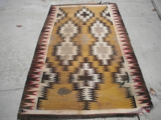 As found: An early 20th century Navajo rug measuring 4'5"x 8'3" with problems that you can see in the pictures.  I have removed the circular stain in the rug since posting  ...