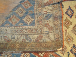 sweet little south Caucasian rug, good colors and some eccentric elements. damage to sides and bottom.                 