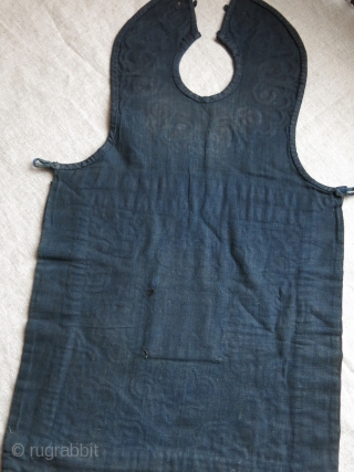 CHINESE minority child’s apron, pieced out of various natural indigo dyed canvas like cotton fabrics. Tiny transparent wires wrapped and embroidered with silk yarns. Traditional Chinese motifs. Used but still in pretty  ...