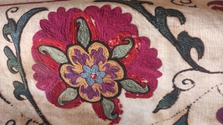 Antique Suzani fragment. Circa 19th Century. Professionally mounted on cotton fabric. Size: 9.8" x 50.6" 25 cm x 129 cm.             