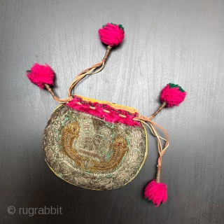 Small purse made in India in the early part of the 20th century.
Embroidered in Zardozi work depicting fish and finished with vivid pink trim and Pom Poms.

Size:  5.5" x 4" -  ...