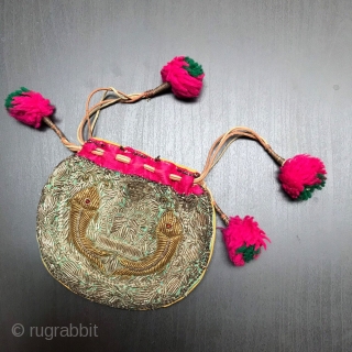 Small purse made in India in the early part of the 20th century.
Embroidered in Zardozi work depicting fish and finished with vivid pink trim and Pom Poms.

Size:  5.5" x 4" -  ...