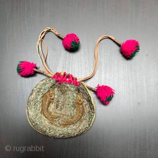 Small purse made in India in the early part of the 20th century.
Embroidered in Zardozi work depicting fish and finished with vivid pink trim and Pom Poms.

Size:  5.5" x 4" -  ...