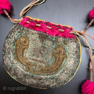 Small purse made in India in the early part of the 20th century.
Embroidered in Zardozi work depicting fish and finished with vivid pink trim and Pom Poms.

Size:  5.5" x 4" -  ...