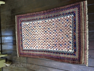 Early Baluch rug, probably from 3rd Qtr 19th Century or earlier. Unusual white field background filled with tiny botehs. Soft thin floppy handle. Low pile throughout and some oxidation of browns. Exhibits  ...