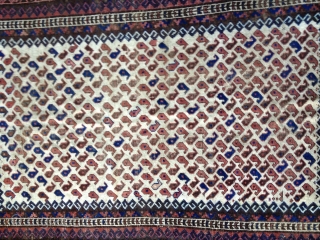 Early Baluch rug, probably from 3rd Qtr 19th Century or earlier. Unusual white field background filled with tiny botehs. Soft thin floppy handle. Low pile throughout and some oxidation of browns. Exhibits  ...