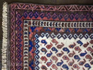 Early Baluch rug, probably from 3rd Qtr 19th Century or earlier. Unusual white field background filled with tiny botehs. Soft thin floppy handle. Low pile throughout and some oxidation of browns. Exhibits  ...