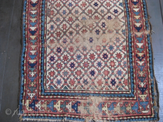 Star Lattice Kazak, probably from third quarter 19th C. Great colors on white field. Areas of serious wear alternating with portions of good pile. Selvedges not original. Soft floppy handle. A good  ...