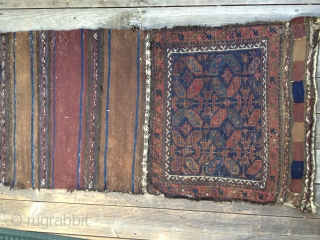 Early Antique Baluch Bag. Complete, with good colors including outstanding blues. Archaic and unusual design. Low pile with some oxidation and some fraying on sides and ends. Nice striped kilim open back.  ...
