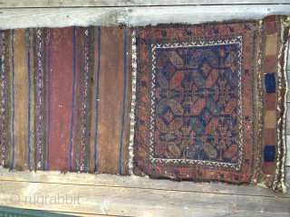 Early Antique Baluch Bag. Complete, with good colors including outstanding blues. Archaic and unusual design. Low pile with some oxidation and some fraying on sides and ends. Nice striped kilim open back.  ...