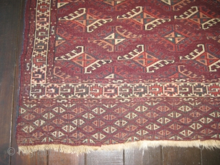 Small Yomud rug, beginning of 20th C. Good,soft pile. Dyrnak guls. Small repair near center, and also two small pink areas in middle of rug edge are repairs. Colors include burgundy background  ...