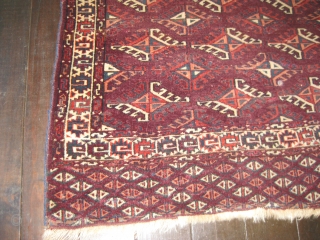 Small Yomud rug, beginning of 20th C. Good,soft pile. Dyrnak guls. Small repair near center, and also two small pink areas in middle of rug edge are repairs. Colors include burgundy background  ...