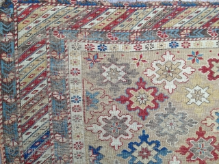 Early Shirvan snowflake design rug, ca 1870. Good natural colors, very low evenly worn pile. Exceptional palette reflecting good age. Missing outer borders on both ends. Yellow field and good variety of  ...