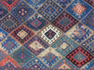 Early Jaf Kurd chuval fragment. Beautiful saturated natural colors that include a good variety of blues and blue-greens. Missing top and bottom borders.  Worn condition and with a patch from another  ...