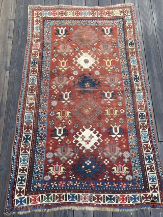 Unusual Antique Caucasian Rug, late 19th Century. Bright saturated colors, mostly all natural with the exception of a light red and possibly the pink. Unusual tulip design field. White main border with  ...