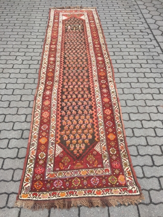 Antique Persian Bidjar runner with a lovelyl couple of Kurdish village people, signed and dated. Wool on wool foundation, size: 365x100cm / 12ft x 3'3''ft , little old moth damage at the  ...