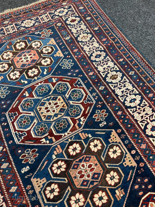 Antique Caucasian Shirvan rug with Kufic border. Beautiful shades of indigo, azure and navy blue are complemented by intricate geometric motifs, woven with precision and skill. The Kufic border adds a touch  ...