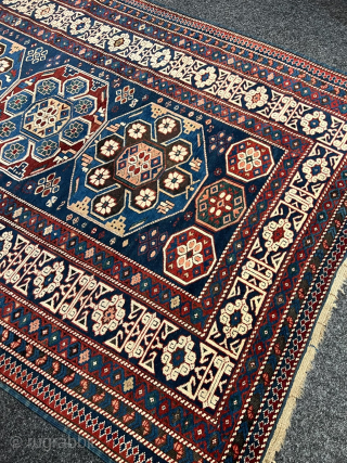 Antique Caucasian Shirvan rug with Kufic border. Beautiful shades of indigo, azure and navy blue are complemented by intricate geometric motifs, woven with precision and skill. The Kufic border adds a touch  ...