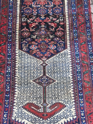 A lovely Persian Bakhtiary long rug displaying two cool looking gentlemen in the centre, size: ca. 345x100cm / 11'3''ft x 3'3''ft , signed and dated at the top. Sides and ends not  ...