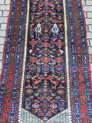 A lovely Persian Bakhtiary long rug displaying two cool looking gentlemen in the centre, size: ca. 345x100cm / 11'3''ft x 3'3''ft , signed and dated at the top. Sides and ends not  ...