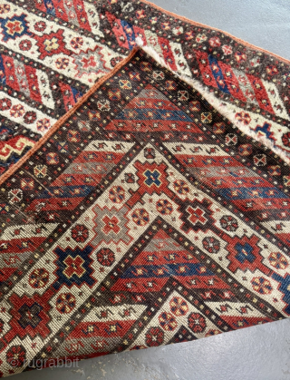 Offered here is an antique Caucasian long rug dating to the 19th century, measuring 325x125cm / 10,7ft by 4,1ft. The composition is centered around a vertical column of classic, stepped Memling guls, ...