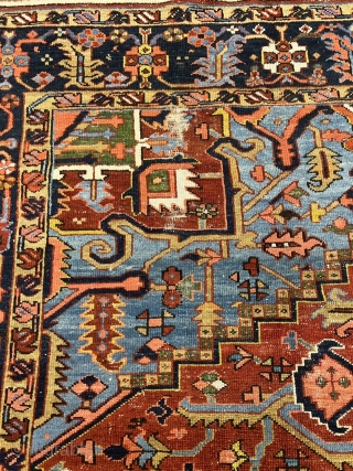 A highly decorative antique Persian Heriz carpet. Beautiful blue corners, size: ca. 345x290cm / 11’3ft by 9’5ft some localized wear.             