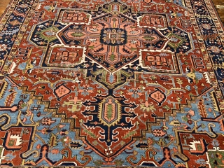 A highly decorative antique Persian Heriz carpet. Beautiful blue corners, size: ca. 345x290cm / 11’3ft by 9’5ft some localized wear.             