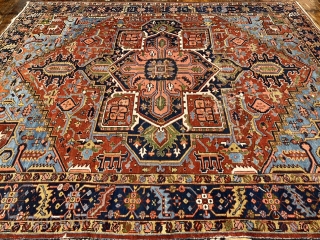 A highly decorative antique Persian Heriz carpet. Beautiful blue corners, size: ca. 345x290cm / 11’3ft by 9’5ft some localized wear.             