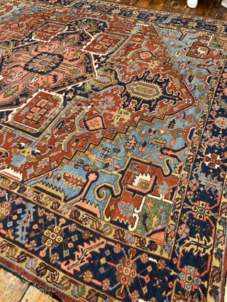 A highly decorative antique Persian Heriz carpet. Beautiful blue corners, size: ca. 345x290cm / 11’3ft by 9’5ft some localized wear.             