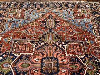 A highly decorative antique Persian Heriz carpet. Beautiful blue corners, size: ca. 345x290cm / 11’3ft by 9’5ft some localized wear.             