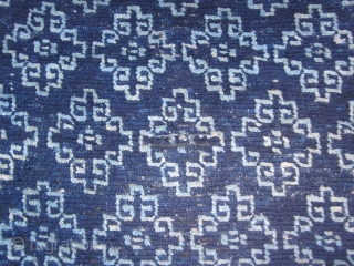 Tibetan Khaden, overall design of cloudbands forming ?guls, light and dark indigo, 30 by 67 inches, possible small repair in field as seen in shots. c.1900 Applied blue edging on all sides. 